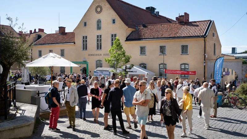 En grupp människor som står framför Donnerska huset.