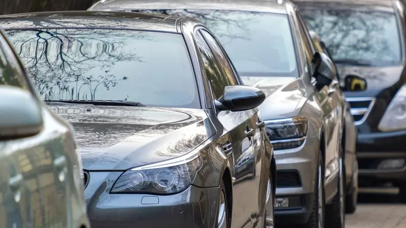 En rad parkerade bilar på en gata i en stad