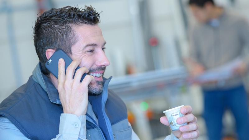 Man sitter och pratar i telefon.